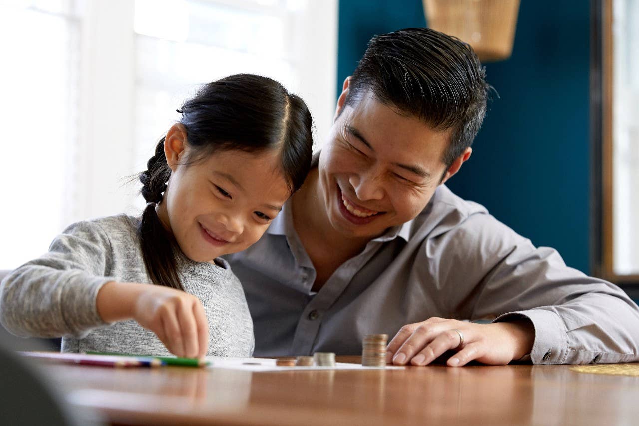Father and daughter counting money