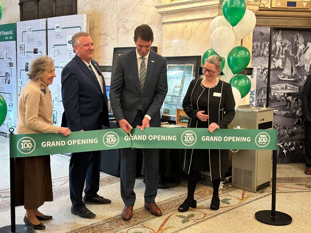 COUNTRY Financial CEO Jim Jacobs cuts the ribbon to officially open the 100th anniversary exhibit at the McLean County Museum of History