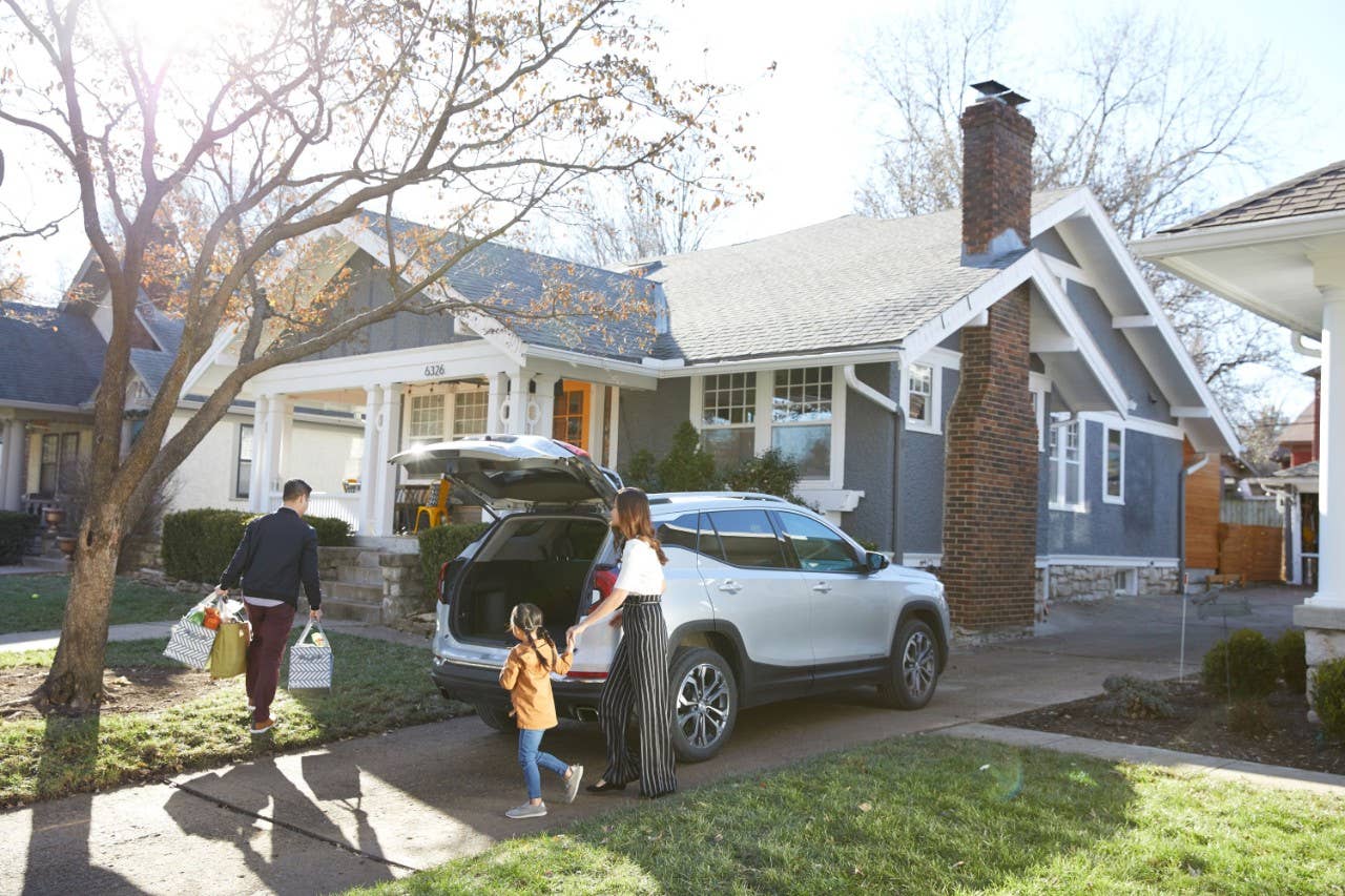 Family walking in house from car