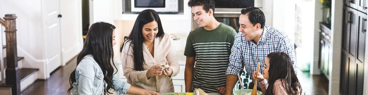 Family making meal at kitchen counter