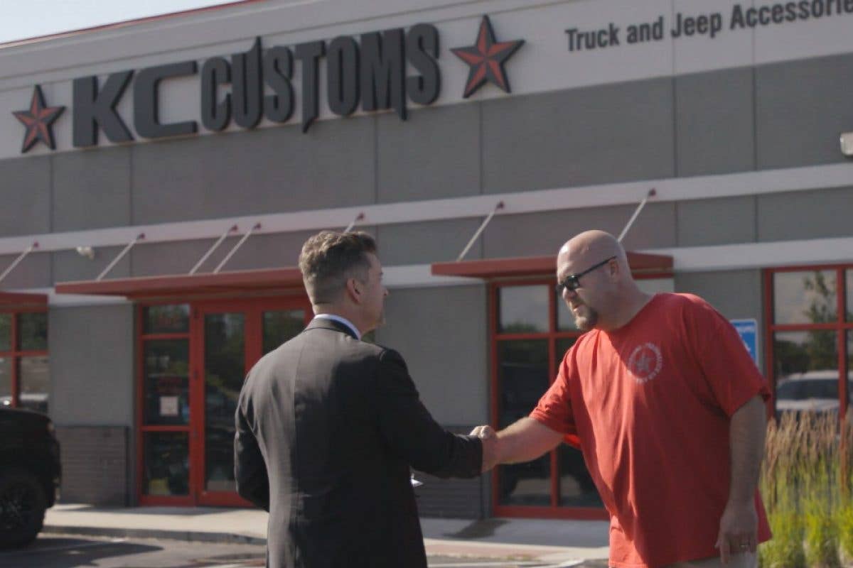 Insurance agent shaking hands with KC Customs owner